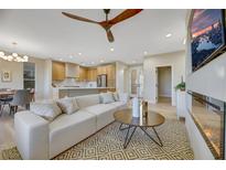 Bright living room featuring a cozy sectional sofa and a modern fireplace at 4660 Fiore Bella Blvd, Las Vegas, NV 89135