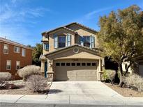 Charming two-story home with a two-car garage, desert landscaping and light blue shutters at 11644 Royal Derwent Dr, Las Vegas, NV 89138