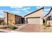 Two-story home with attached two-car garage and landscaped front yard at 16 Via Stefano, Henderson, NV 89011