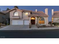 Two-story house with a large front yard, two-car garage, and attractive landscaping at 2412 Eagleridge Dr, Henderson, NV 89074