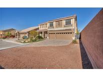 Two-story house with solar panels, three-car garage, and landscaped yard at 5728 Collier Falls Ave, Las Vegas, NV 89139