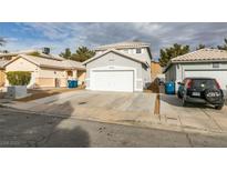 Two-story house with attached garage and driveway, landscaped yard, and neighboring houses visible at 5934 Clear Valley Ave, Las Vegas, NV 89142