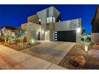 Stunning two-story home featuring modern design, stone accents, and desert landscaping at 6800 Equinox Cliff St, Las Vegas, NV 89135