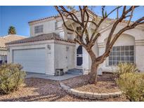 Charming two-story home with stucco exterior, tile roof, attached garage, and low maintenance landscaping at 1179 King Arthur Ct, Henderson, NV 89002