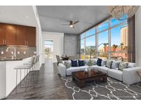 Bright living room featuring large windows, modern decor, sleek bar seating, and views of the city at 353 E Bonneville Ave # 313, Las Vegas, NV 89101