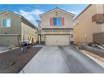 Two-story house with beige siding, a two-car garage, and landscaping at 6271 Port Astoria Ct, Las Vegas, NV 89122