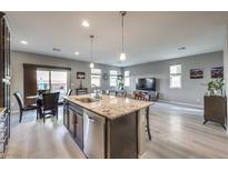 Open-concept kitchen featuring granite counters, stainless appliances, and island with seating at 6482 Twin Harbors Ct, Las Vegas, NV 89141