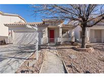 House exterior featuring a red door, two-car garage, and landscaped walkway at 5372 Polo Grounds St, Las Vegas, NV 89148