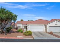 Charming single-story home with a well-maintained front yard and a two-car garage at 5683 Whale Watch St, Las Vegas, NV 89113