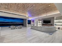 Expansive living room featuring a modern fireplace and city views at 673 Falcon Cliff Ct, Henderson, NV 89012