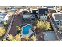 Expansive backyard featuring a pool, slide, gazebo, basketball court, and solar panels on house roof at 260 E Desert Rose Dr, Henderson, NV 89015