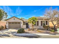 Single-story home with a two-car garage and desert landscaping at 4129 Cackling Goose Dr, North Las Vegas, NV 89084