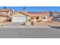 Single-story home with solar panels and landscaped yard at 1550 Desertaire Way, Las Vegas, NV 89110