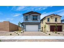 Charming two-story home with a two-car garage, brick driveway, and well-maintained landscaping at 633 N Water St, Henderson, NV 89015