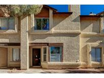 Tan stucco exterior of charming two-story home with wood accents at 537 Kristin Ln, Henderson, NV 89011