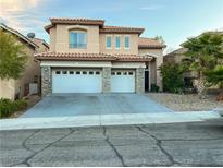 Charming two-story home with a tile roof, stone accents, and a spacious two-car garage at 10673 Blue Nile Ct, Las Vegas, NV 89144