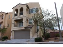 Two-story house with attached garage and balcony at 9869 Juno Hills St, Las Vegas, NV 89178