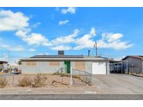 Ranch style home with solar panels and a spacious driveway at 120 Maple St, Henderson, NV 89015