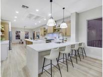 Modern kitchen with large island, stainless steel appliances, and white quartz countertops at 1928 Oliver Springs St, Henderson, NV 89052