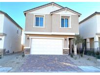 Two-story house with a white garage door and brick accents at 4771 Illustria Ave, Las Vegas, NV 89141