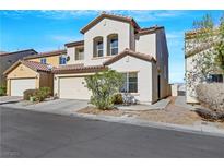 Two-story house with attached garage and landscaping at 5064 Sacred Datura Ave, Las Vegas, NV 89139