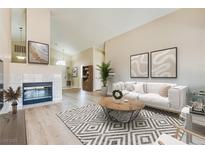 Bright living room featuring a fireplace and wood-look floors at 3706 Rose Canyon Dr, North Las Vegas, NV 89032