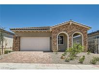 Charming single-story home featuring stone accents, desert landscaping, and a two-car garage at 104 Barkset Way, Henderson, NV 89011