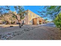 Inviting two-story building with desert landscaping, stone accents, and ample parking spaces at 2020 Rancho Lake Drive Dr # 205, Las Vegas, NV 89108