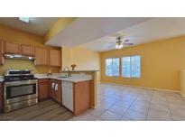 Bright kitchen featuring stainless steel appliances, light countertops, and a breakfast bar opening to the living area at 2020 Rancho Lake Drive Dr # 205, Las Vegas, NV 89108