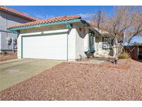 House exterior featuring a white single-story home with a two-car garage and well-maintained landscaping at 2846 Belleza Ln, Henderson, NV 89074