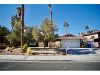 Single story home with a landscaped front yard, attached garage, and driveway at 7393 Puritan Ave, Las Vegas, NV 89123