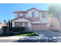 Charming two-story home featuring a tile roof, a two-car garage, and a well-maintained lawn at 319 Fox Lake Ave, Las Vegas, NV 89148