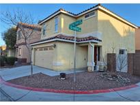 Two-story house with attached garage and desert landscaping at 3367 Villa Fiori Ave, Las Vegas, NV 89141