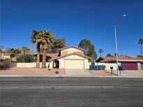 Single-story house with palm trees and a two-car garage at 5882 W Viking Rd, Las Vegas, NV 89103