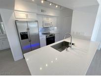 Bright kitchen features stainless steel appliances, white cabinets, and modern countertops at 7255 W Sunset Rd # 2046, Las Vegas, NV 89113