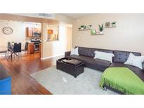 Inviting living room featuring a modern leather sofa, ottoman, and decorative shelving at 2120 Ramrod Ave # 1112, Henderson, NV 89014