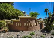 Community sign for The Meridian, surrounded by lush landscaping and palm trees against a clear blue sky at 230 E Flamingo Rd # 212, Las Vegas, NV 89169