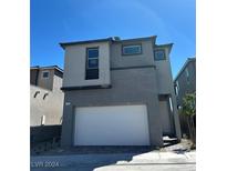 Two-story home featuring a modern design, a two-car garage, neutral paint and a well-maintained landscape at 1558 Rock Kestrel St, Las Vegas, NV 89138