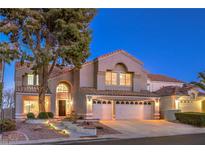 Two-story house with a three-car garage and landscaped front yard at 18 Tarryall Ter, Henderson, NV 89074