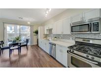 Modern kitchen with stainless steel appliances and white cabinetry at 251 S Green Valley Pkwy # 4813, Henderson, NV 89012