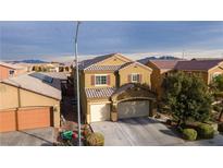 Two-story house with attached garage,landscaped yard, and neighborhood view at 4920 Blue Rose St, North Las Vegas, NV 89081