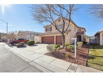 Two-story house with brown double-door garage and landscaped front yard at 5857 Red Dawn St, North Las Vegas, NV 89031