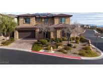 Charming two-story home featuring stone accents, tile roof, solar panels and lush landscaping at 12002 Tramonto Ave, Las Vegas, NV 89138