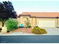 Charming single-story home featuring a well-manicured front yard and a two-car garage at 5048 Orchid Springs St, Las Vegas, NV 89148