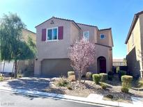 Charming two-story home with a well-manicured front yard and a two-car garage at 11467 Monte Isola St, Las Vegas, NV 89141