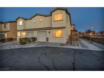 Two-story house with attached garage and landscaping at 2134 William Holden Ct, Las Vegas, NV 89142