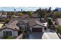 Aerial view of single-story house with pool and landscaped yard at 8229 Flowing Rapids Ct, Las Vegas, NV 89131