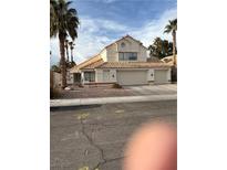 Two-story house with three-car garage, tile roof, and desert landscaping at 2225 Angelfire St, Las Vegas, NV 89128