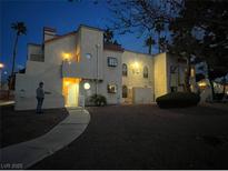 Night view of a two-story building with landscaping at 2961 Juniper Hills Blvd # 102, Las Vegas, NV 89142