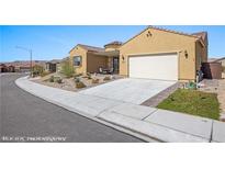 Charming single-story home with a well-maintained front yard, two-car garage, and inviting desert landscape at 1143 Tortoise Mountain Dr, Mesquite, NV 89034